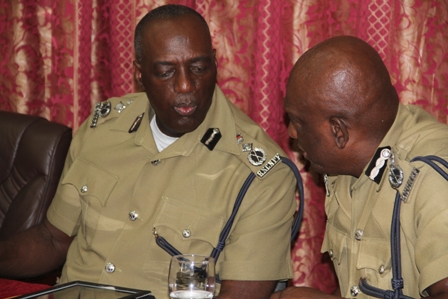 (L-R) Commissioner of the Royal St. Christopher and Nevis Police Force Celvin Walwyn and Assistant Commissioner of Police, Nevis Division Robert Liburd discuss during the annual New Year’s Blessing ceremony on January 4, 2013, at the Divisional Headquarters in Charlestown